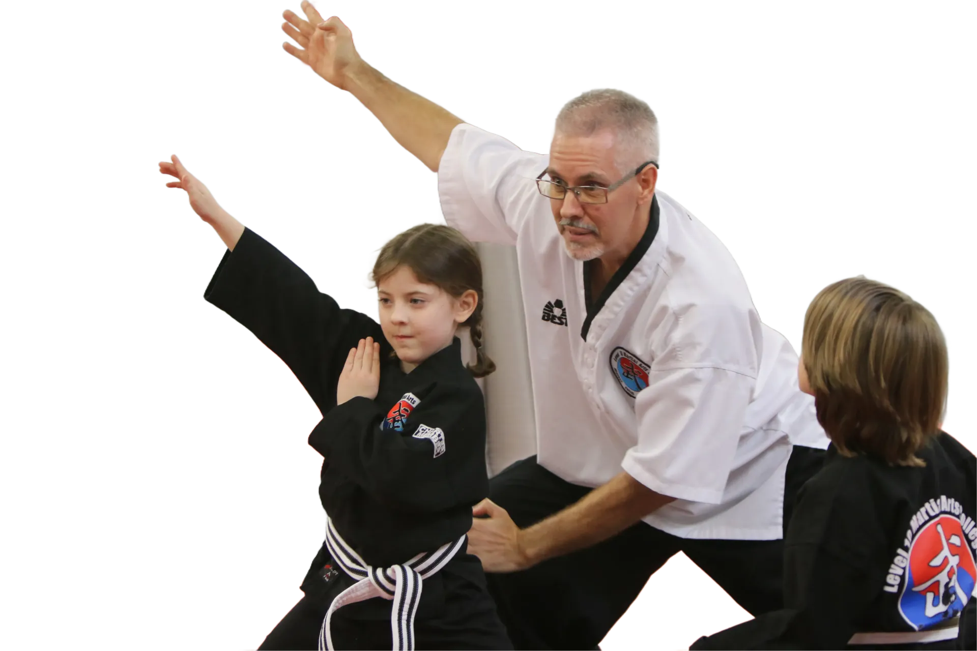 Martial arts instructor and two students practicing a blocking pose at Level 10 Martial Arts in Palm Harbor