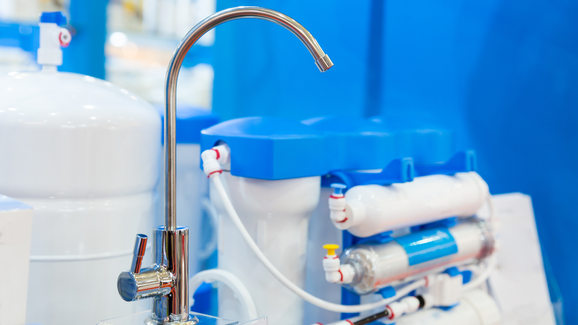 A close up of a water filter with a faucet attached to it.