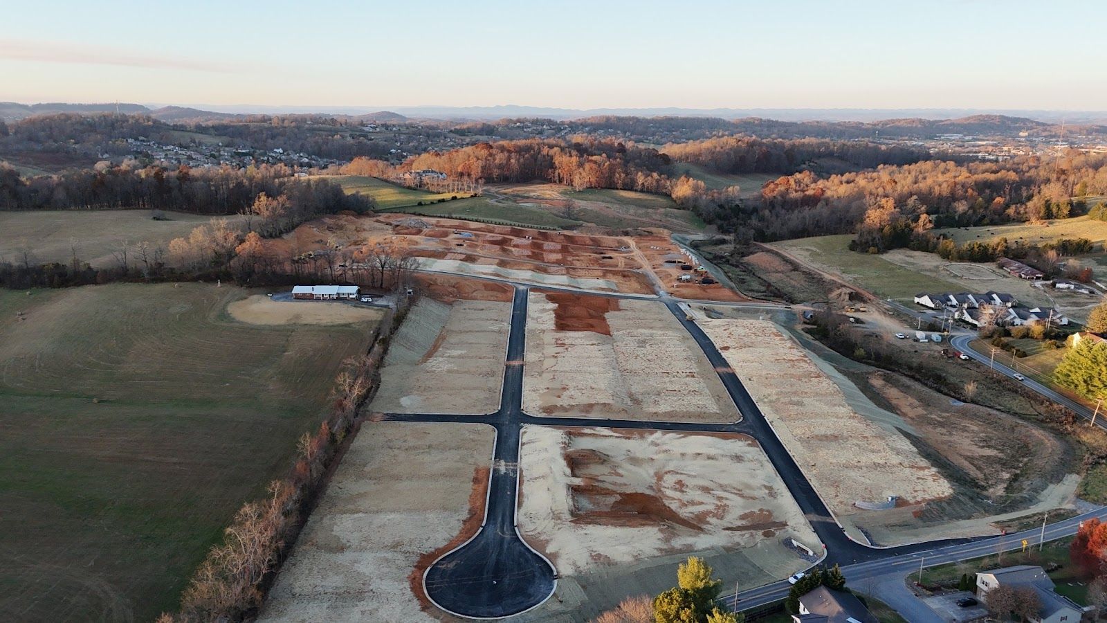 An aerial view of a residential development in the countryside.