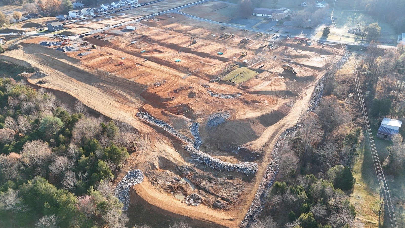 An aerial view of a construction site in the middle of a forest.