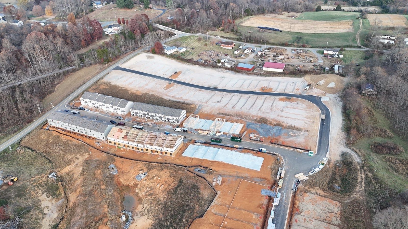 An aerial view of a construction site in the middle of a forest.