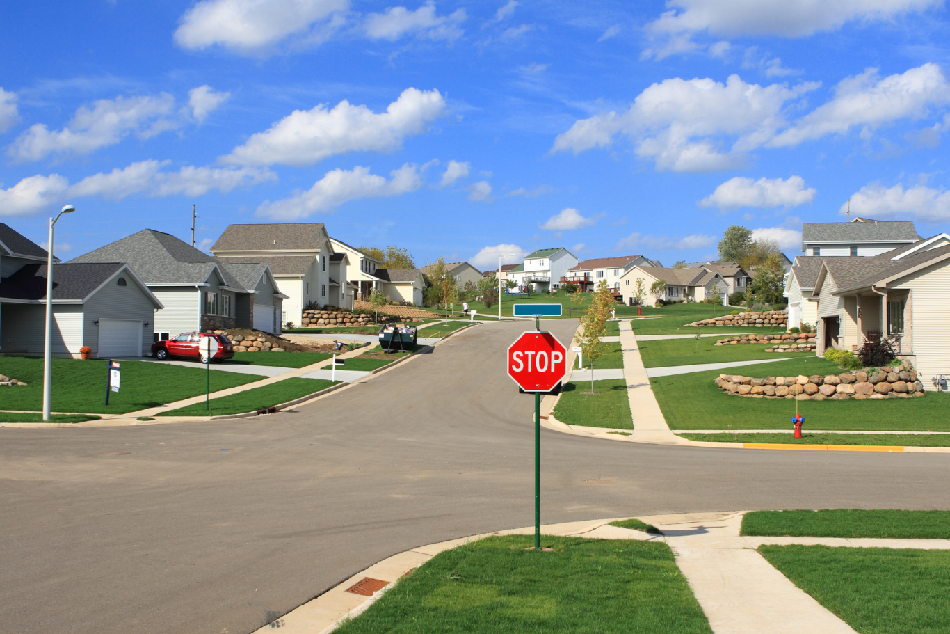 A stop sign is in the middle of a residential street