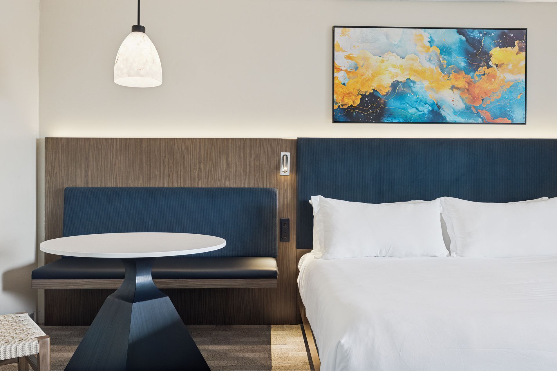 A hotel room with two beds and a ceiling fan