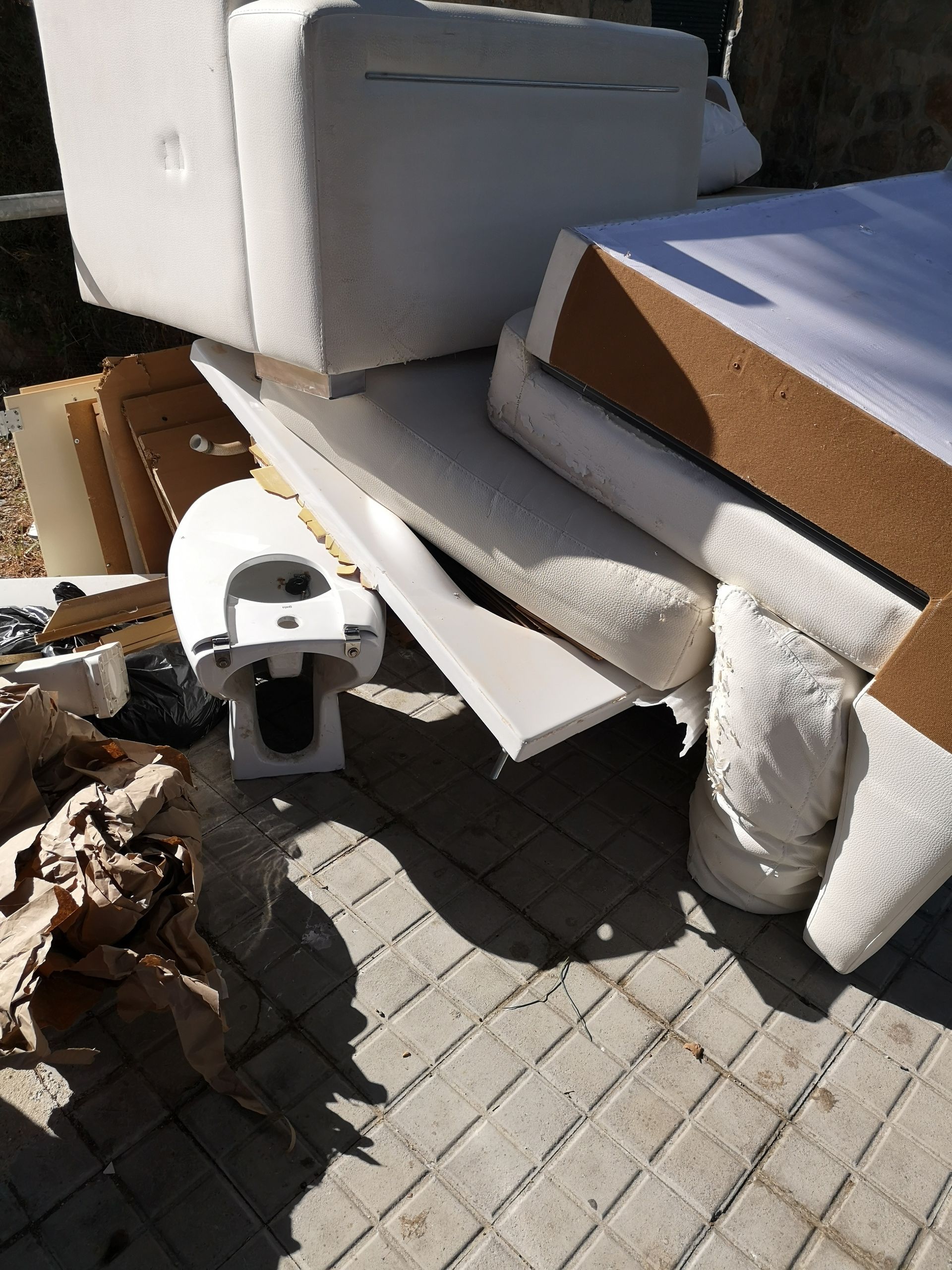 A pile of styrofoam is sitting on a brick sidewalk.