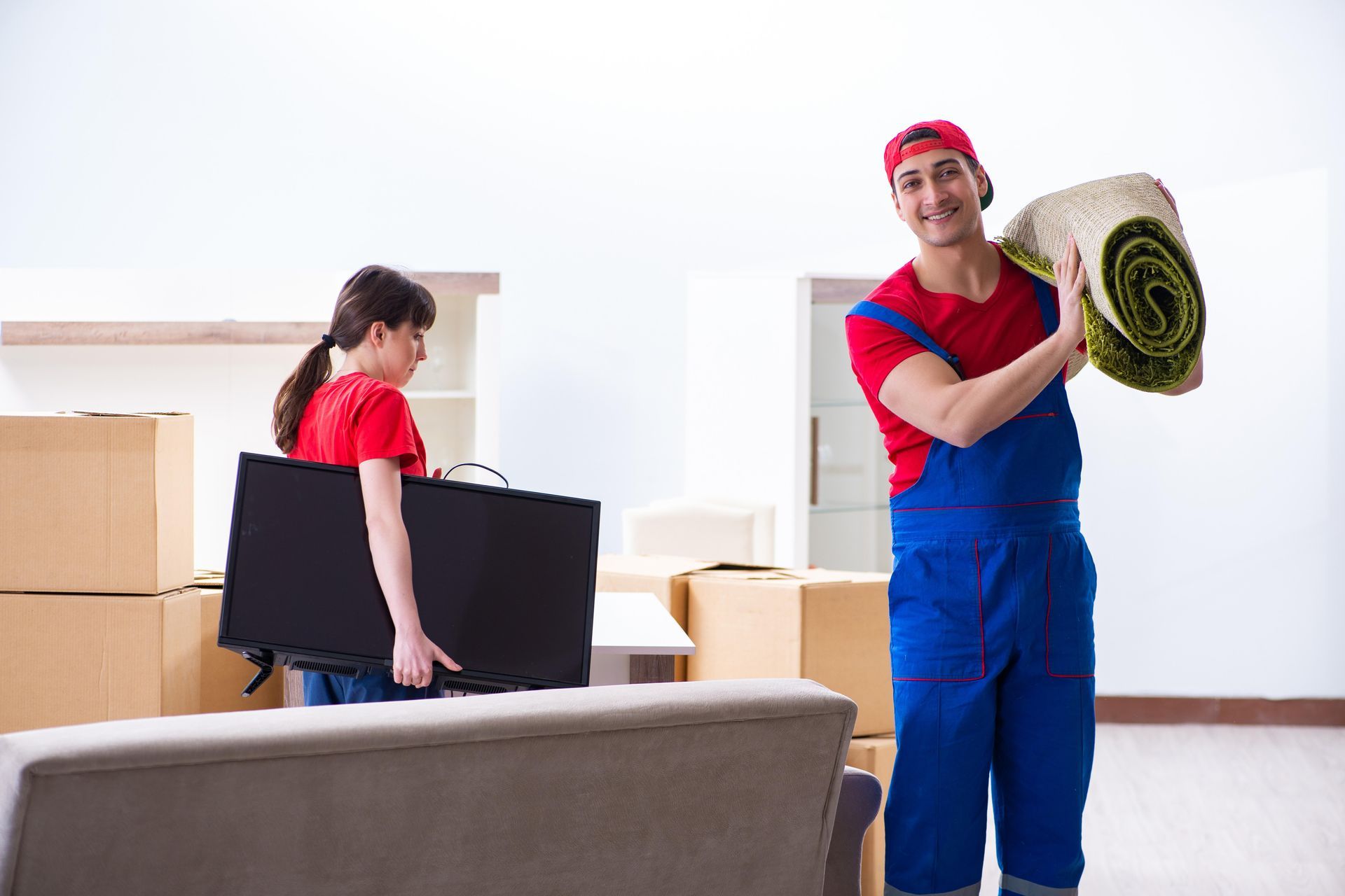 A man and a woman are moving into a new home.