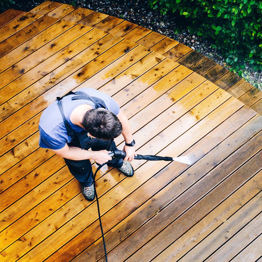 Professional Worker Cleaning a Dirty Deck Professional Worker Cleaning a Dirty Deck