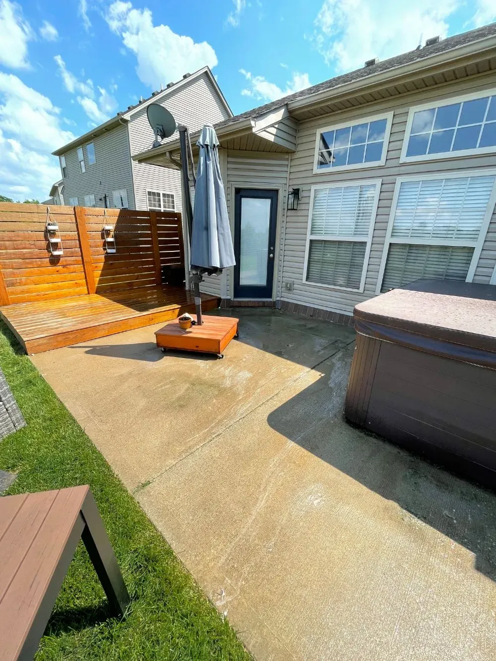 There is a hot tub in the backyard of a house.