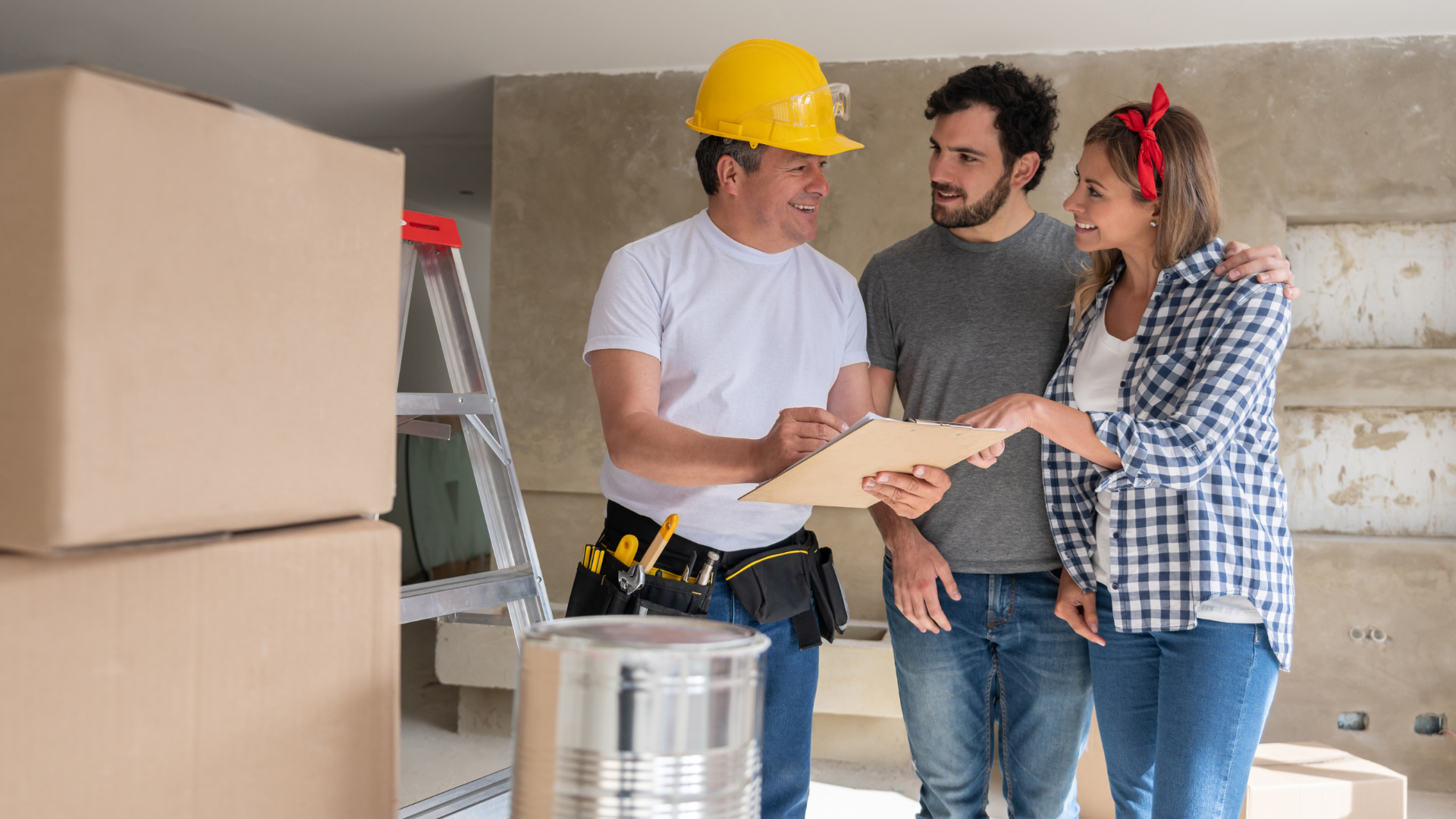 Construction worker, couple reviewing paperwork, interior renovation setting.