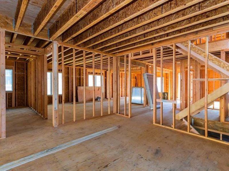 The inside of a house under construction with wooden beams.