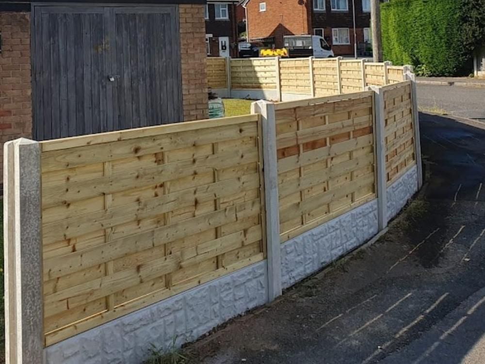 Hit and miss fence panels between concrete posts and rock faced gravel boards, stepped down a sloping boundary in Nether Edge, Sheffield