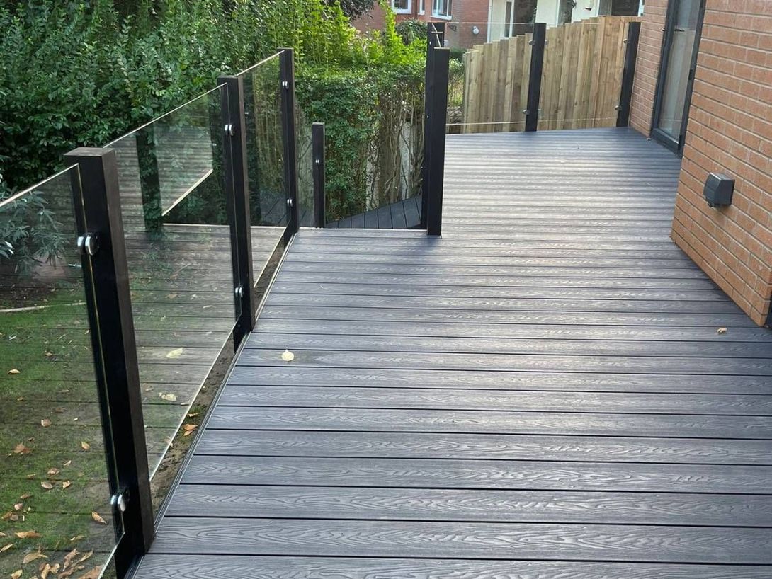 Raised composite decking with glass balustrade installed by Decking Sheffield