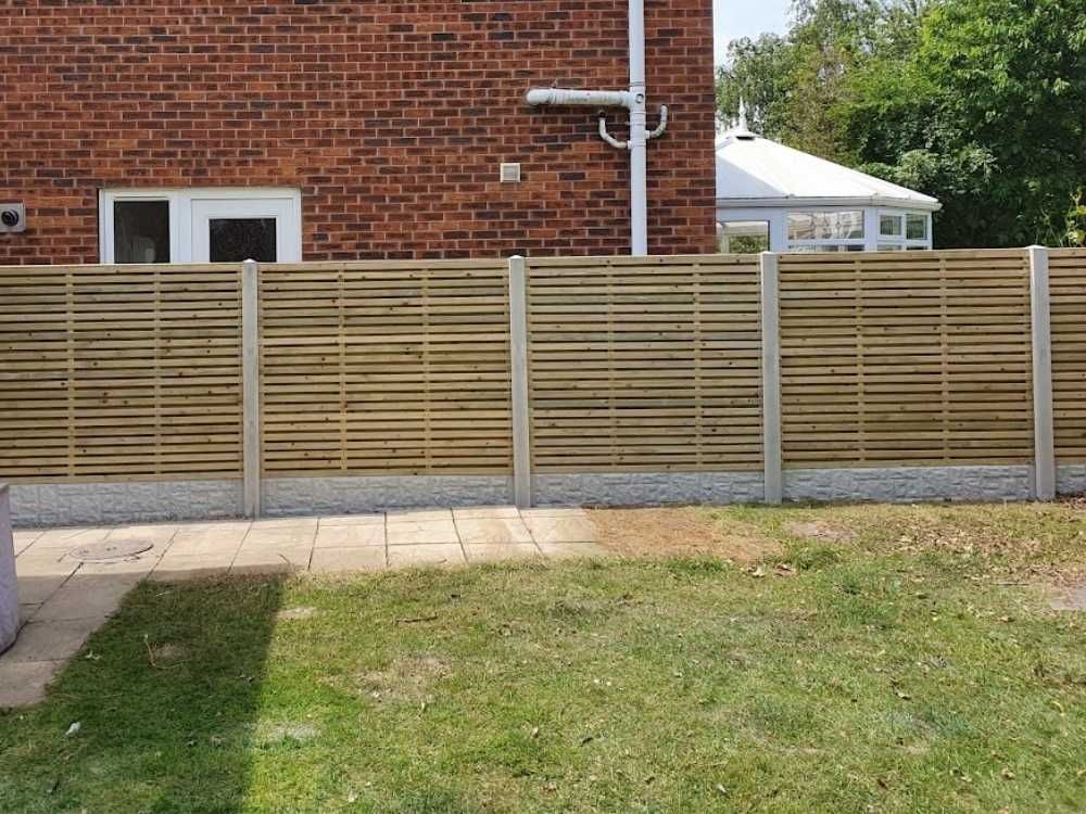 Slatted timber fence panels with concrete posts and rock faced gravel boards along a rear garden in Hillsborough, Sheffield