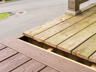showing a completed section of timber decking against newly laid composite decking