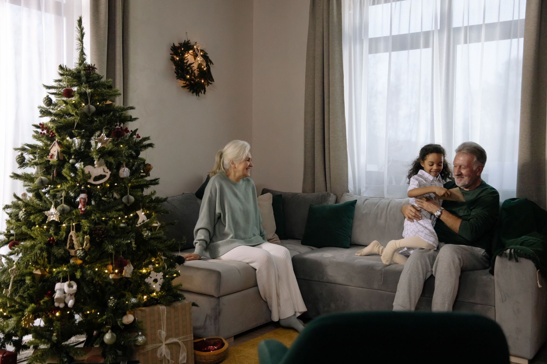 Two retirees spending time with grandchild in the living room