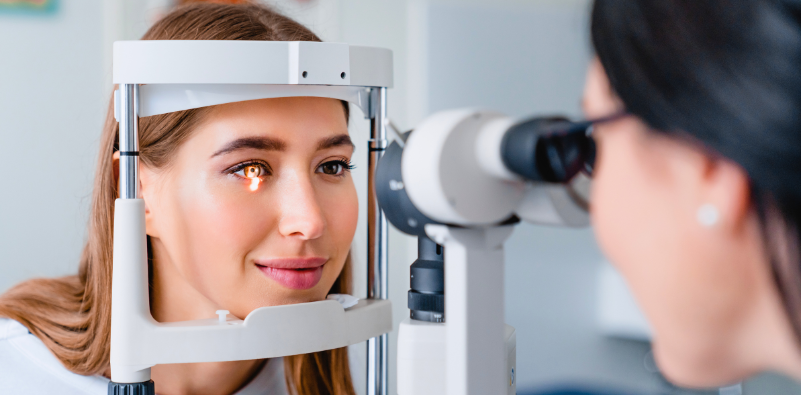 Female optometrist carrying out an eye exam, testing for healthcare and vision 
