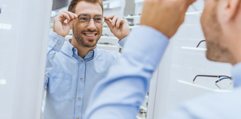A gentleman trying on new glasses in the opticians