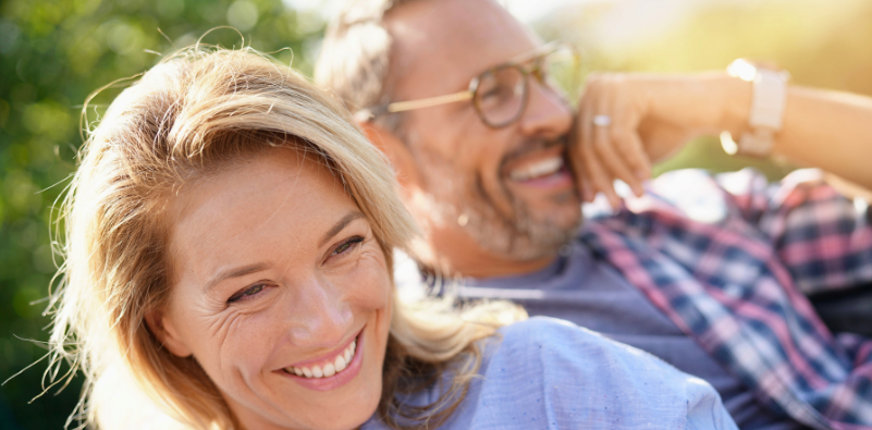 Couples sit in the park, sharing smiles