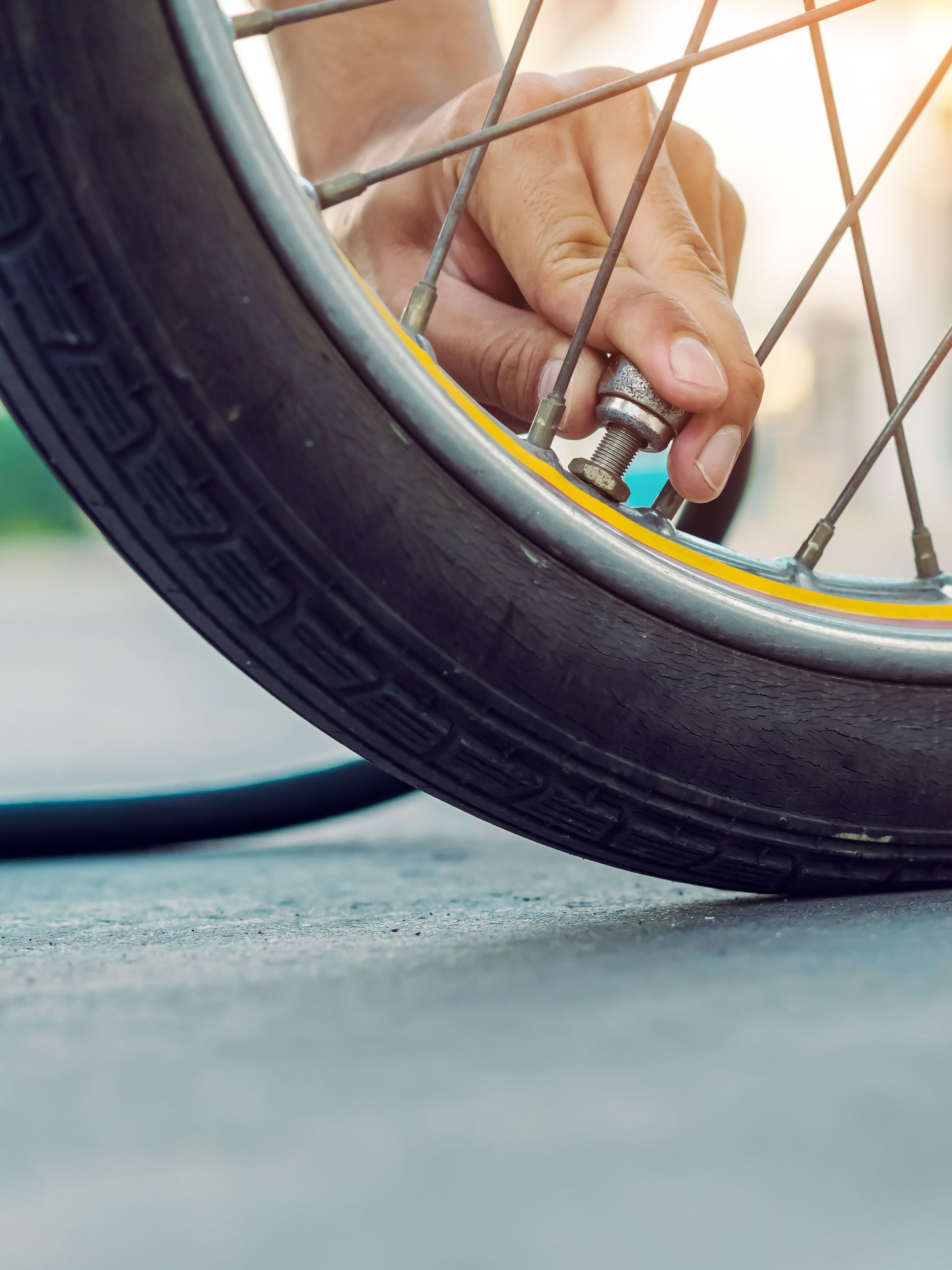 A person is pumping air into a bicycle tire.