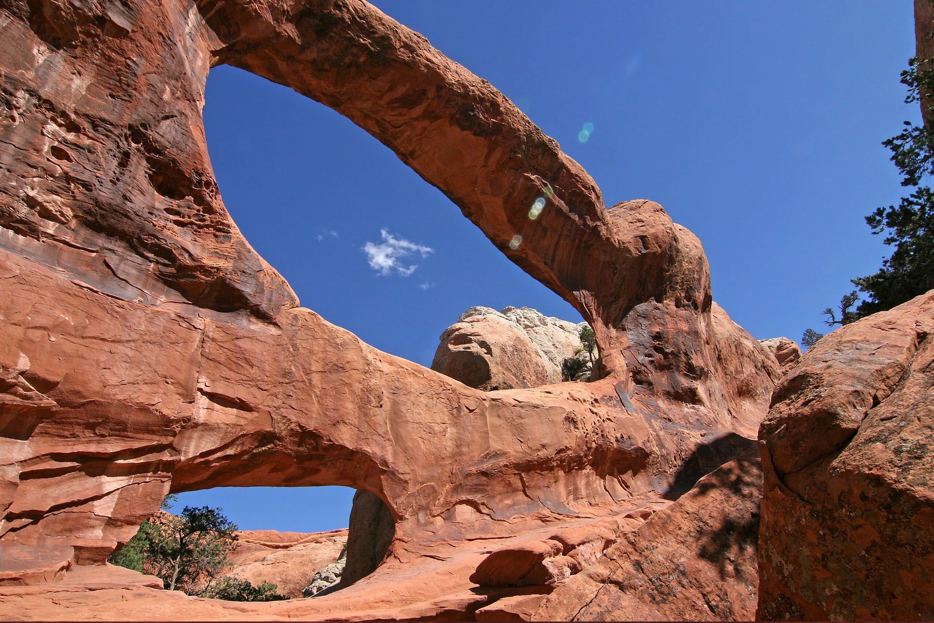 Double O Arch shows two giant openings in the sandstone stacked on top of each other.