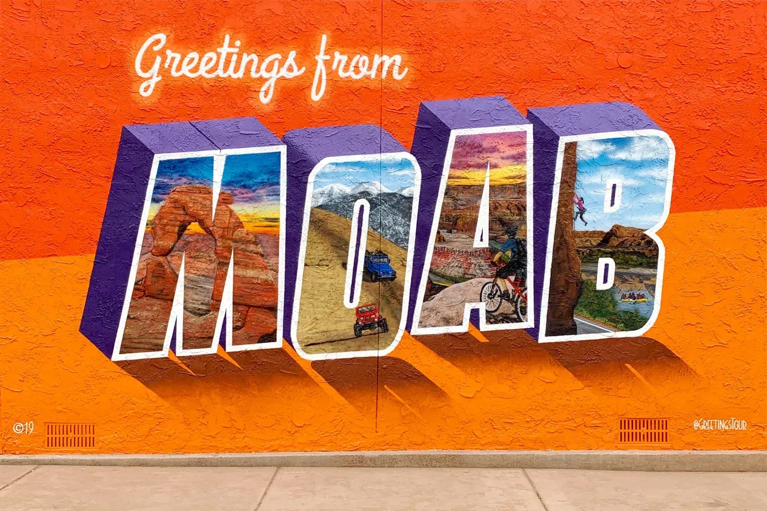 Greetings from Moab wall mural next to a sidewalk.