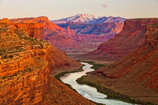 A river running through a canyon with mountains in the background.