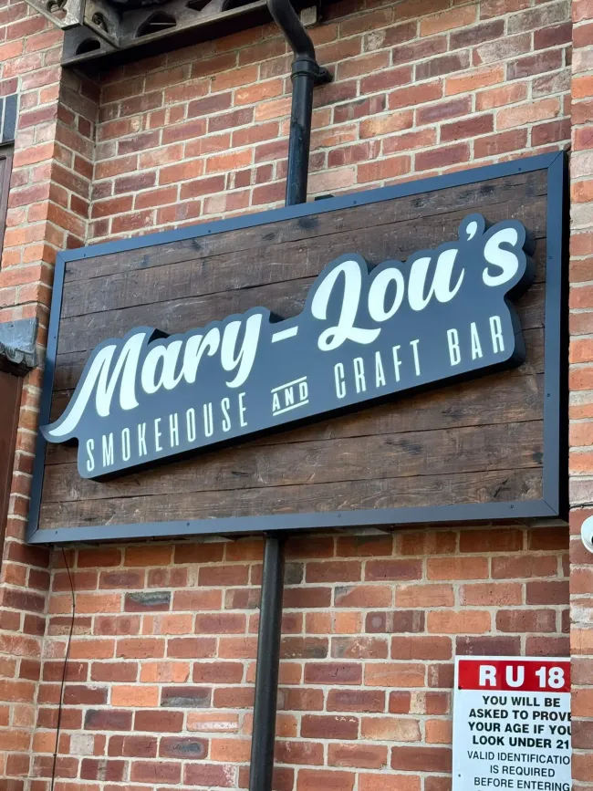 Mary Lou’s Antietam Bar & Grill sign on a brick building, blue and white lettering
