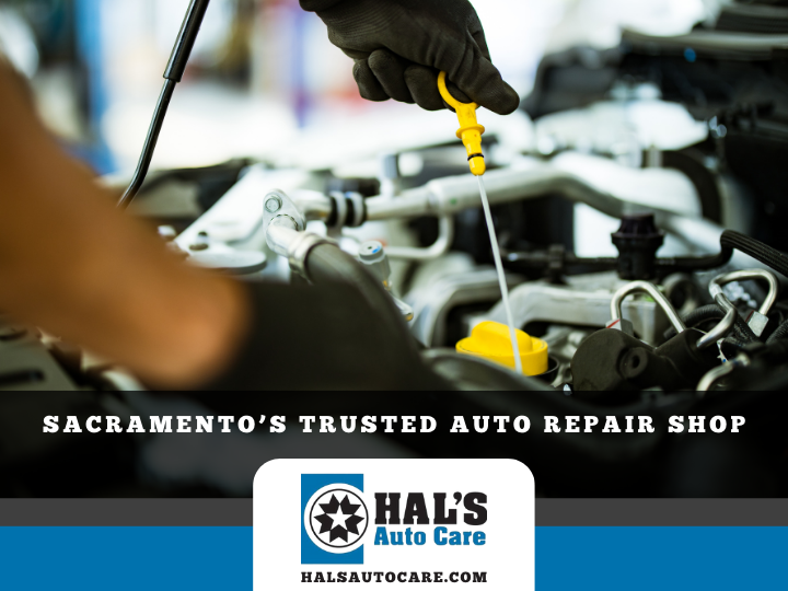 Mechanic checking oil in a car engine at Hal's Auto Care, Sacramento. Dark gloves, yellow dipstick. | Hal's Auto Care