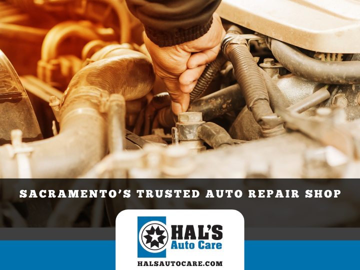 Mechanic working on car engine at Hal's Auto Care shop in Sacramento.