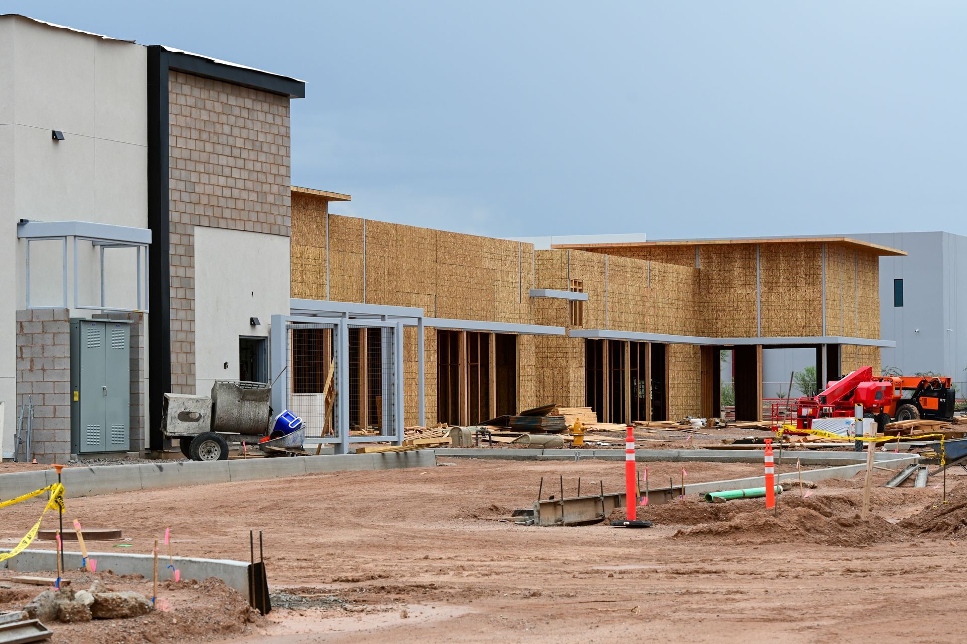 Construction site: Building in progress with wooden framing and concrete work.