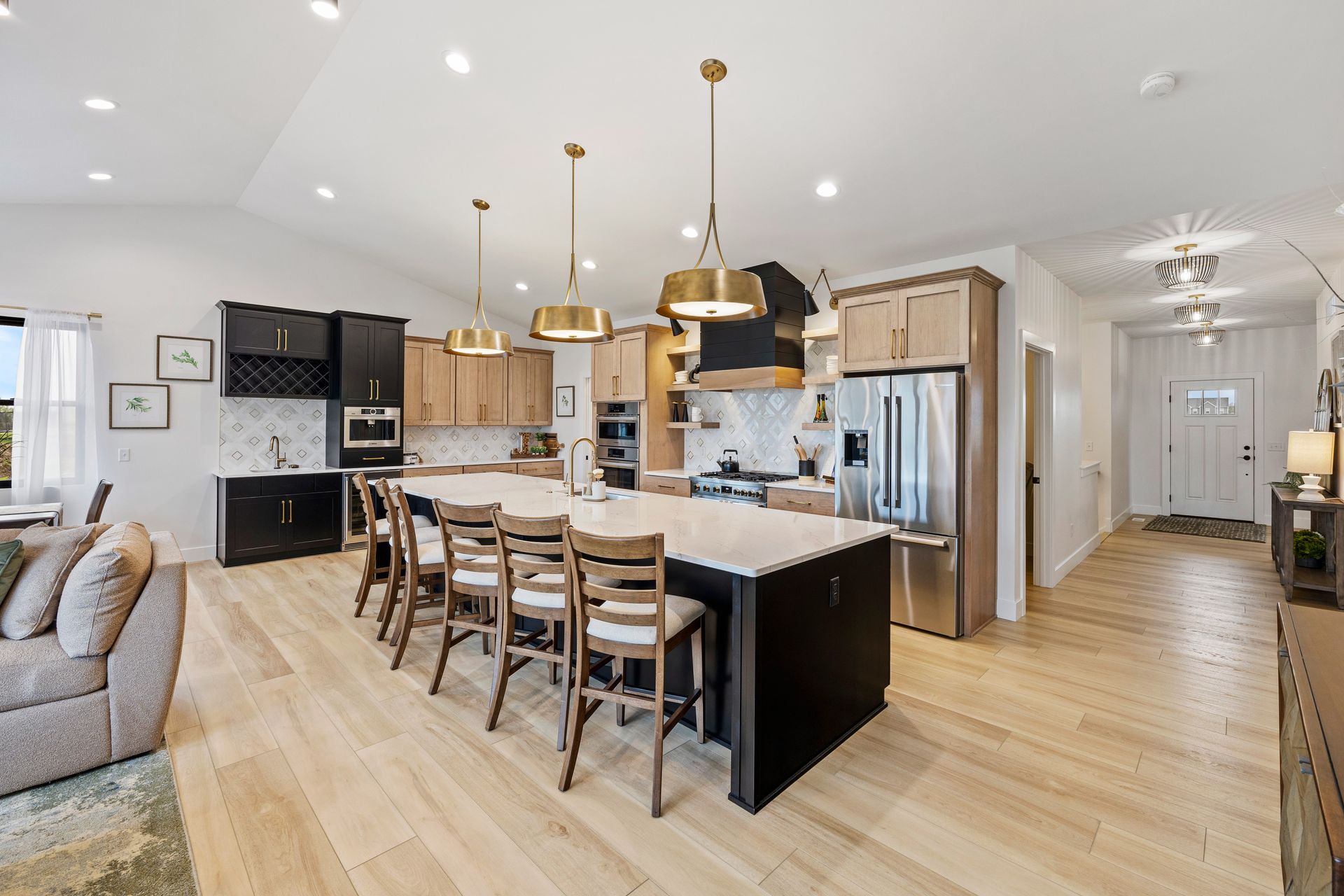 A large kitchen with a large island and stainless steel appliances.