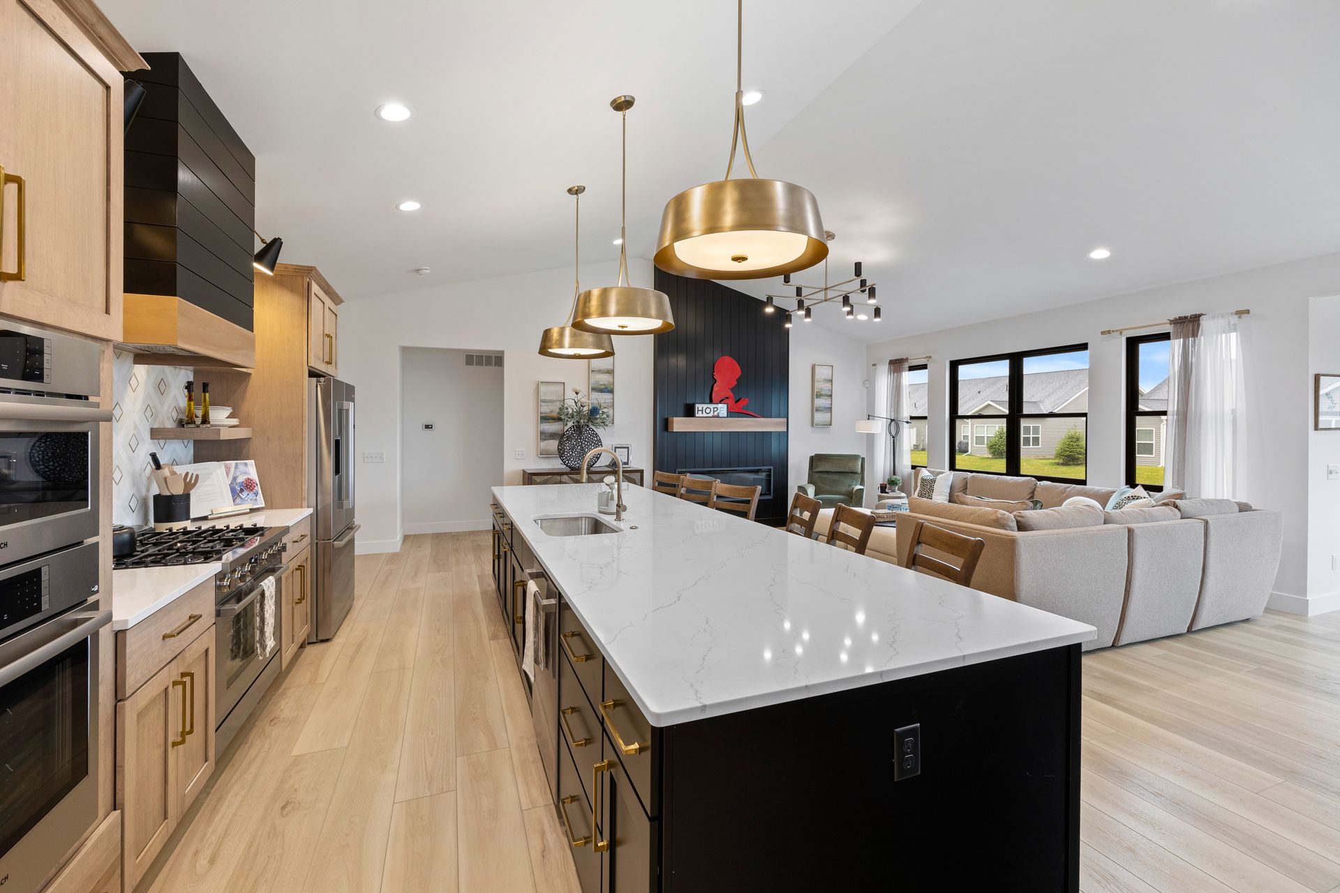 A kitchen with a large island and stainless steel appliances.