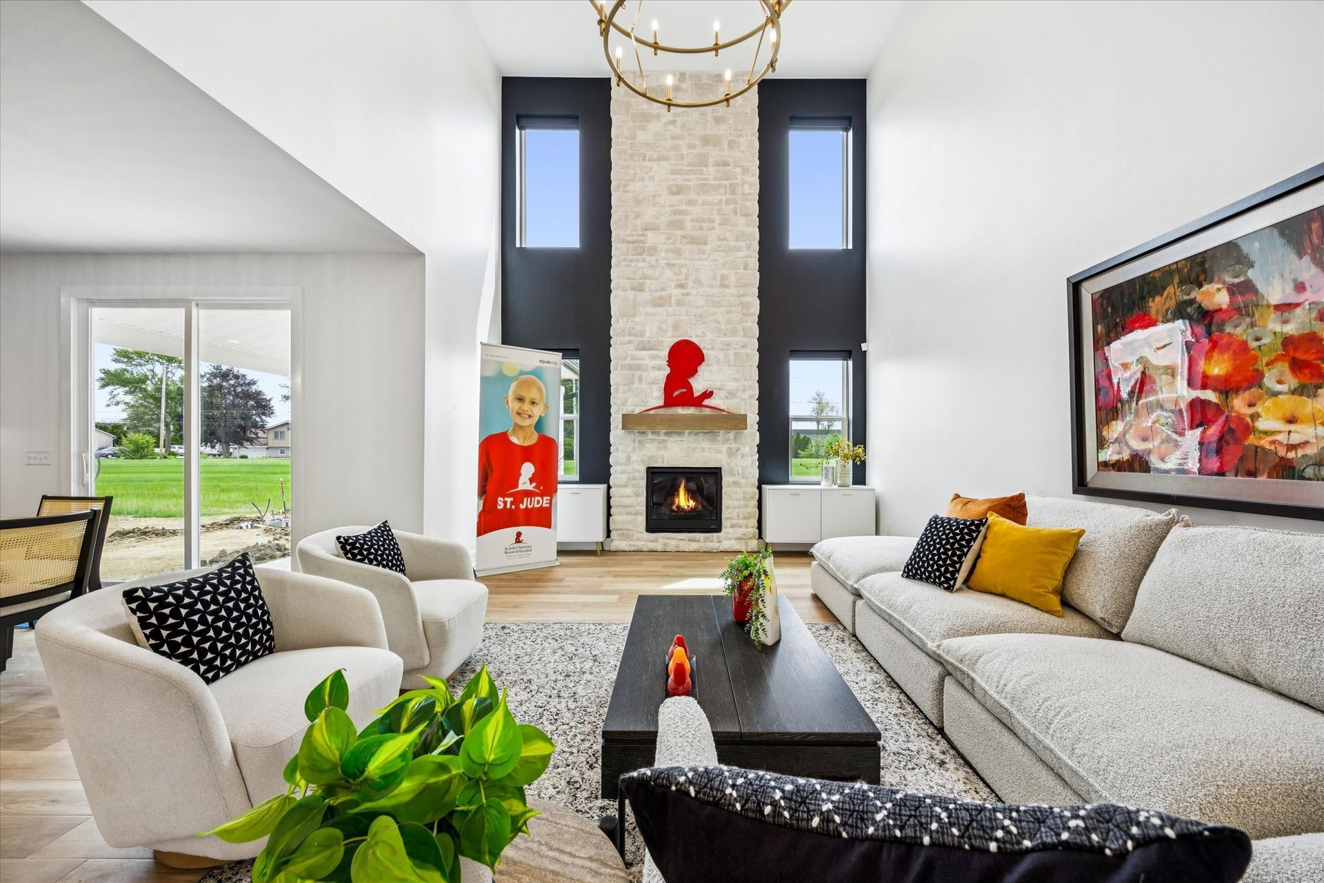 A living room with a couch , chairs , coffee table and fireplace.