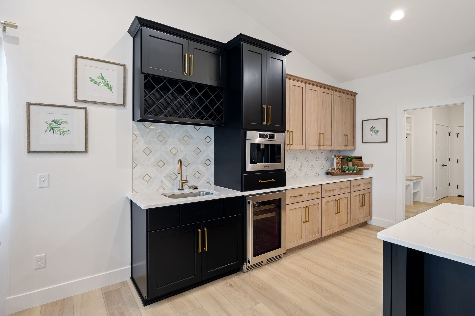 A kitchen with black cabinets , wooden cabinets , stainless steel appliances and a wine rack.