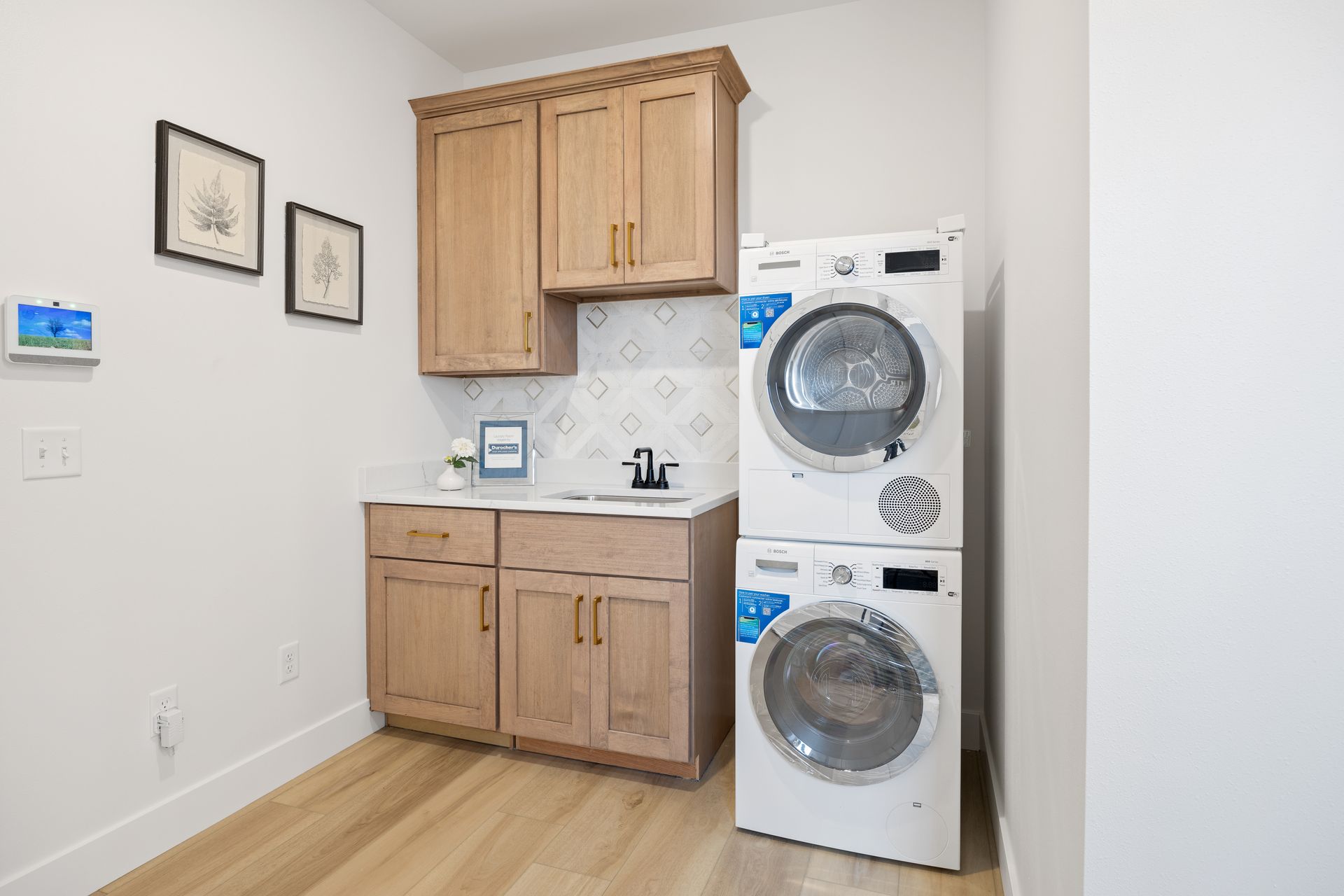 A laundry room with a washer and dryer stacked on top of each other.