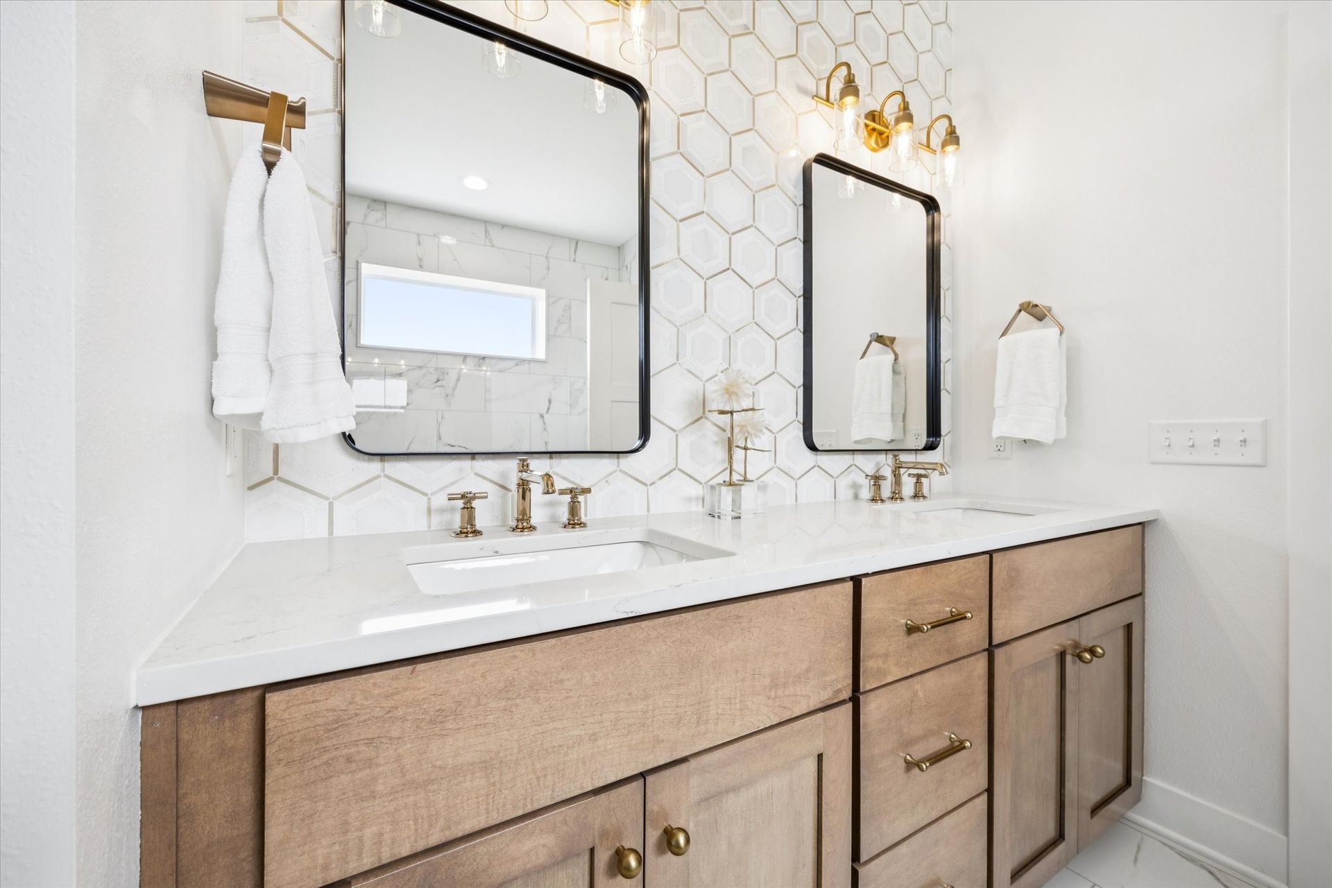 A bathroom with two sinks and two mirrors.