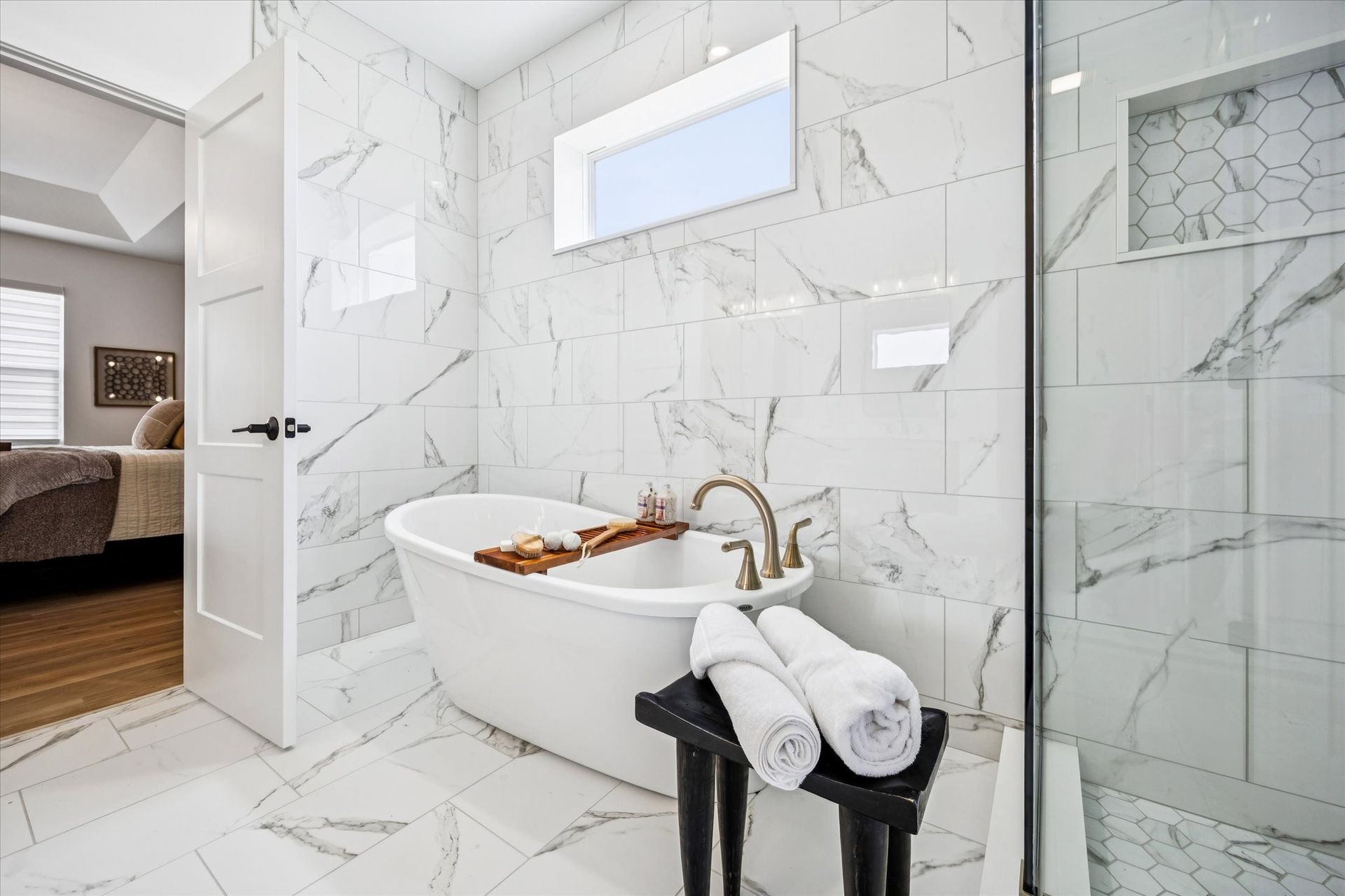 A bathroom with a bathtub and a walk in shower.