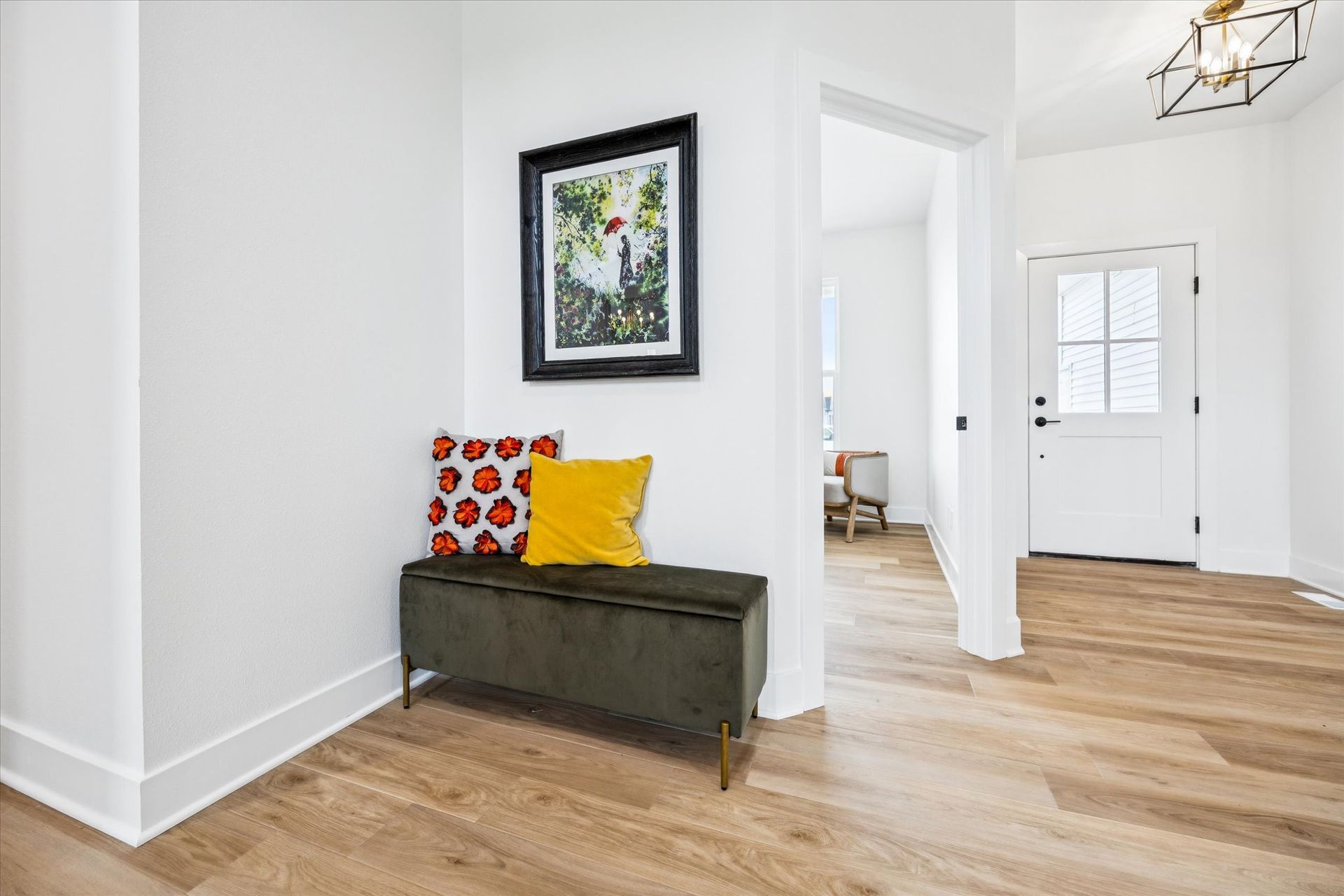 A hallway with a bench and a picture on the wall.