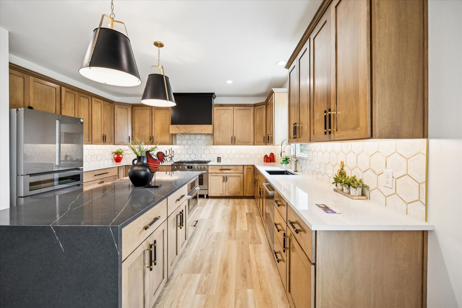 A kitchen with wooden cabinets , stainless steel appliances , and a large island.