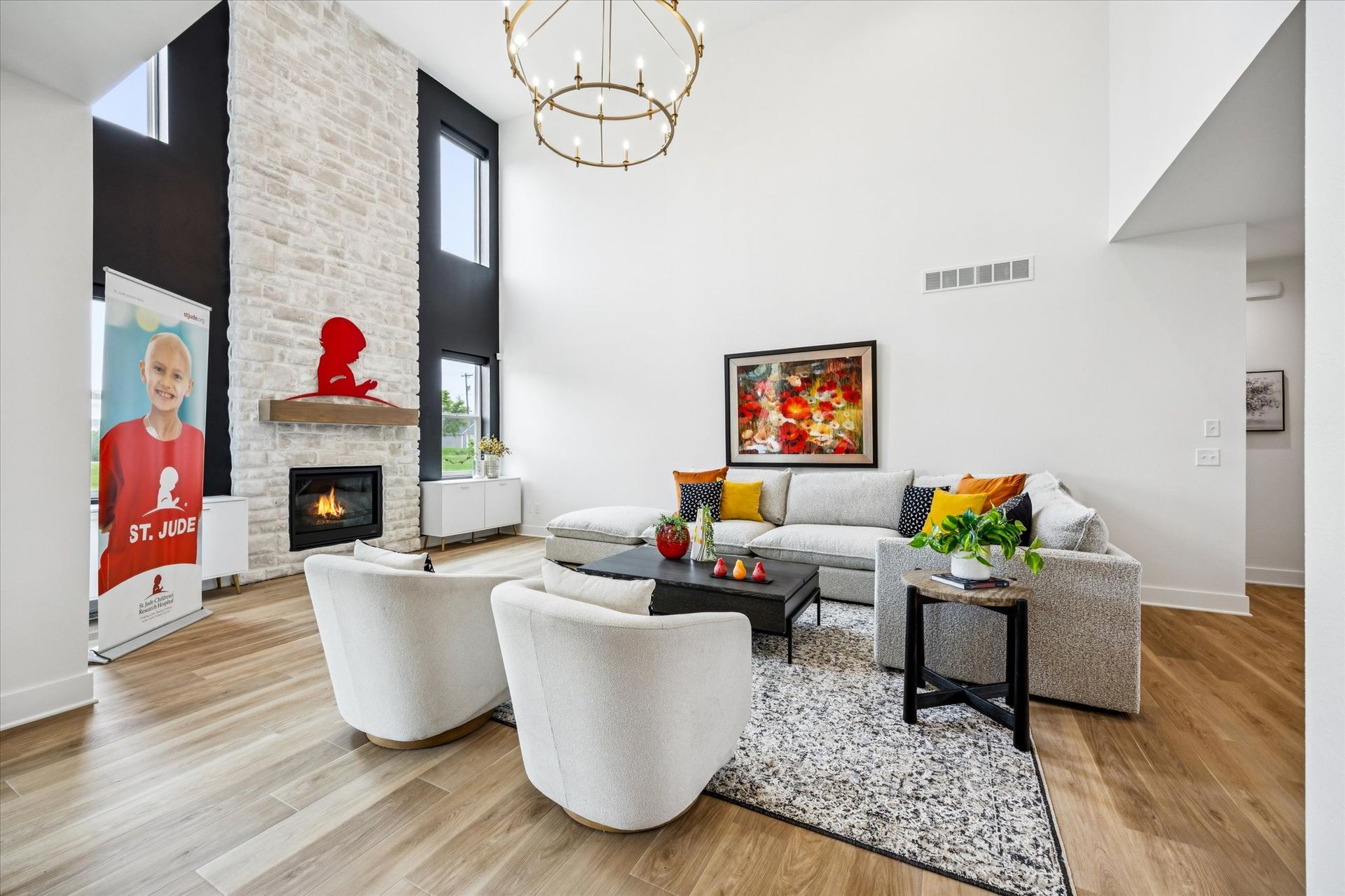 A living room with a couch , chairs , coffee table and fireplace.