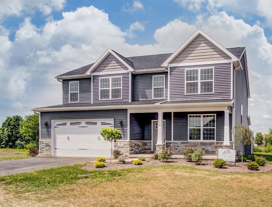 A large house with a lot of windows and a large garage.