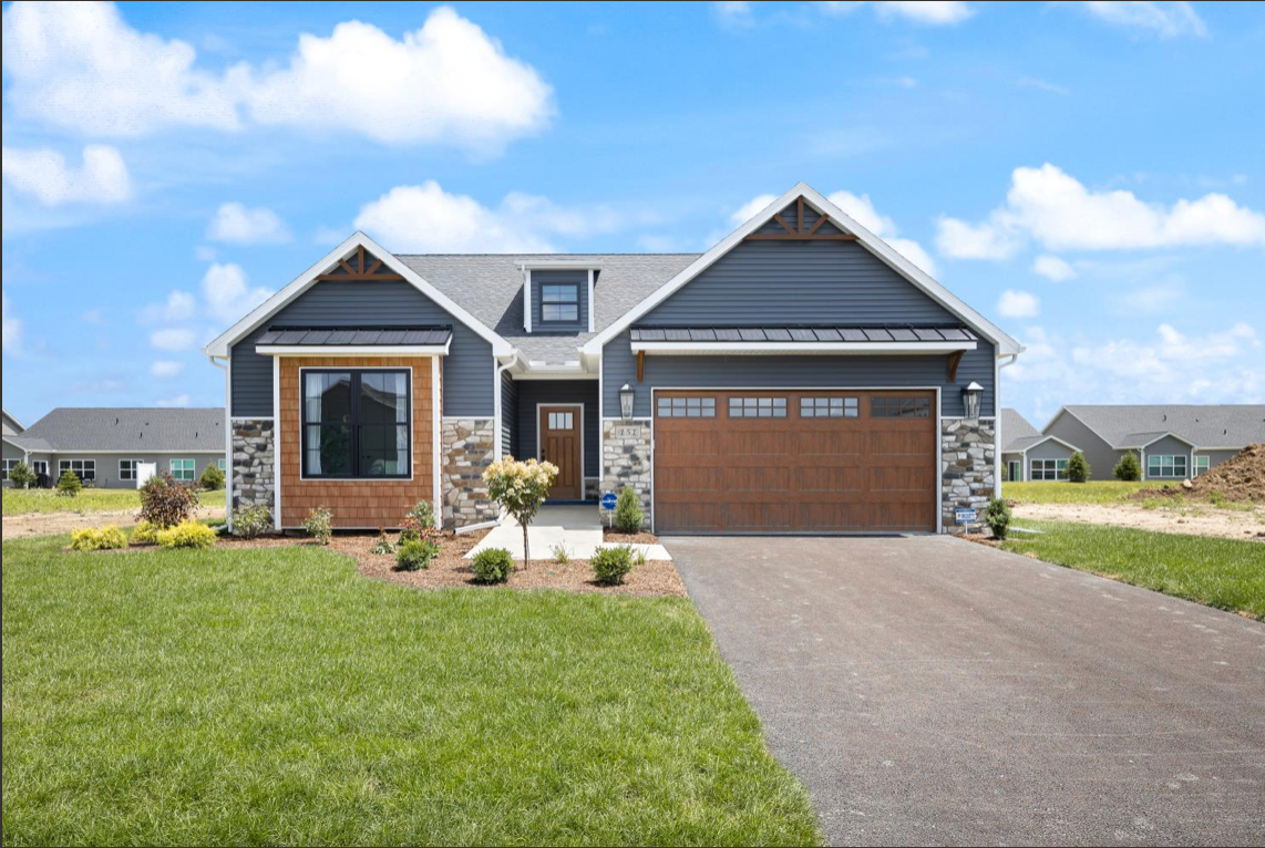 The front of a house with a large garage and a driveway.