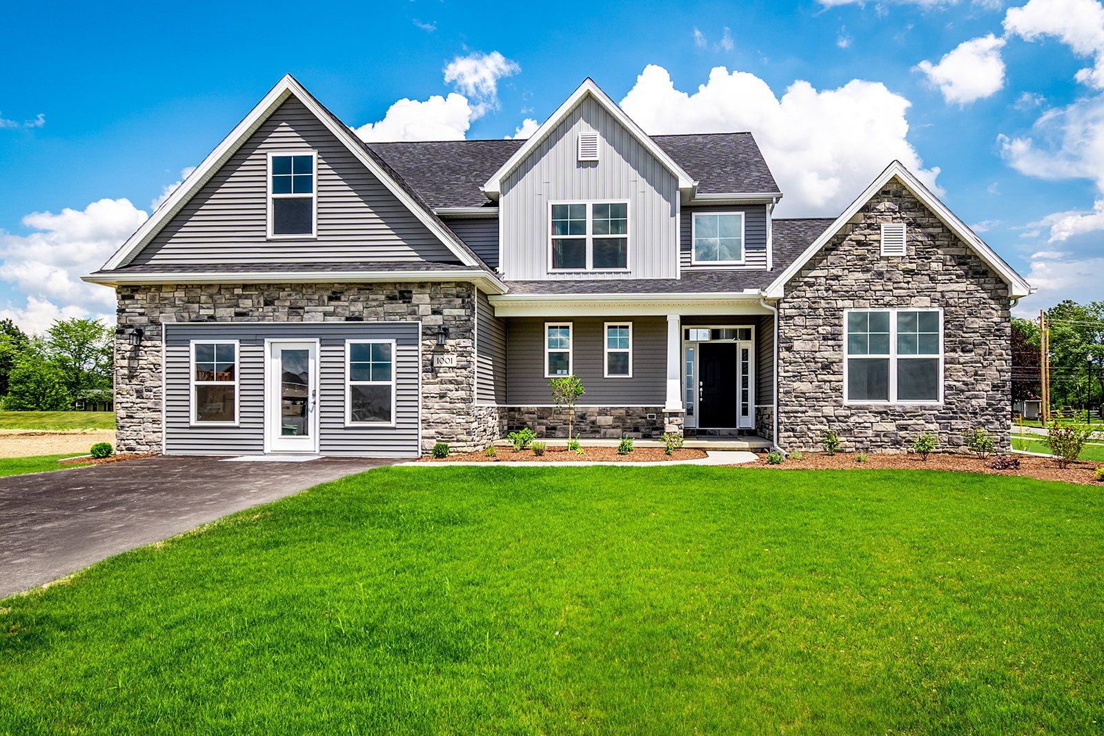 A large house with a large lawn in front of it.