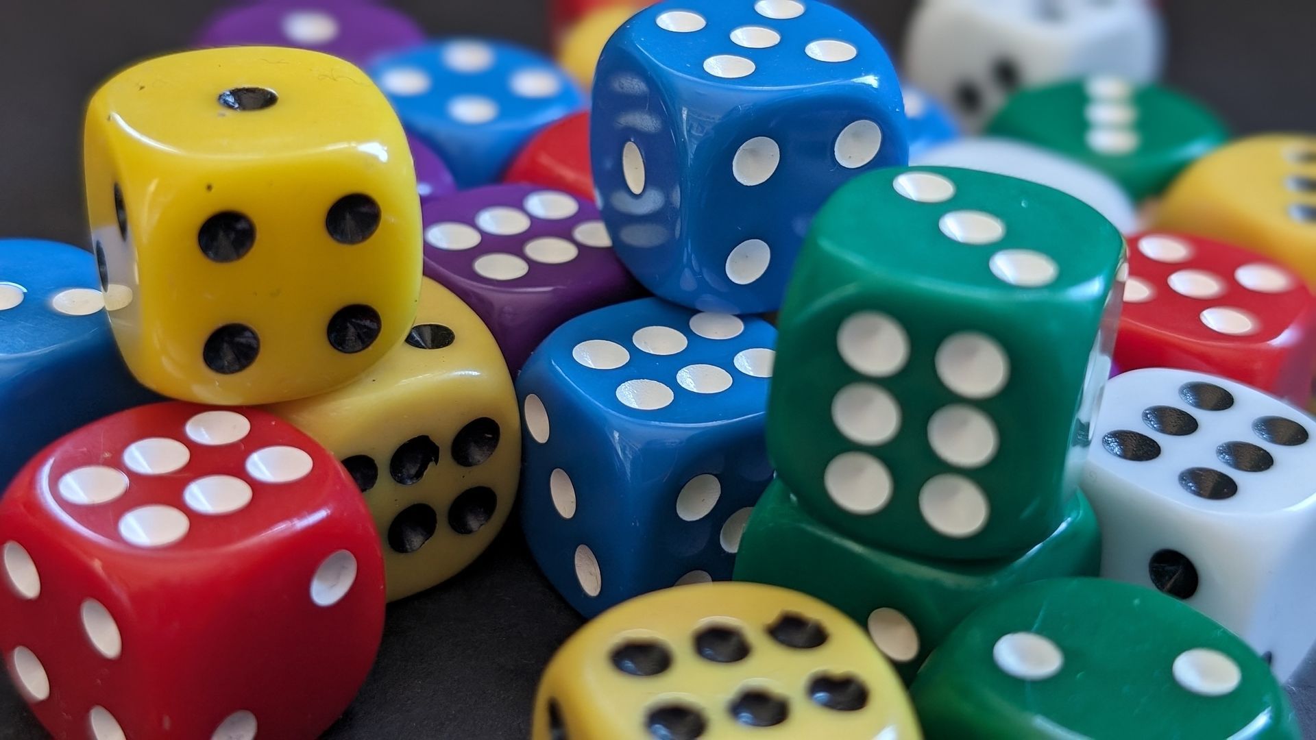 A jumble of 6-sided dice in different colors
