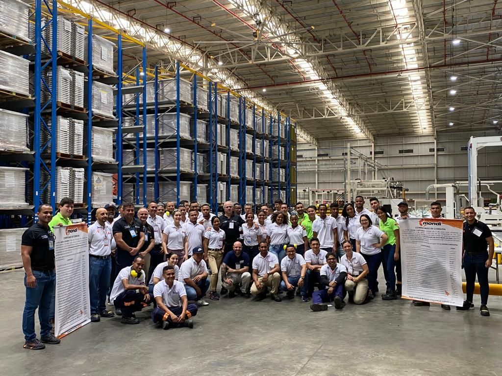 Un grupo de personas posa para una fotografía en un almacén.