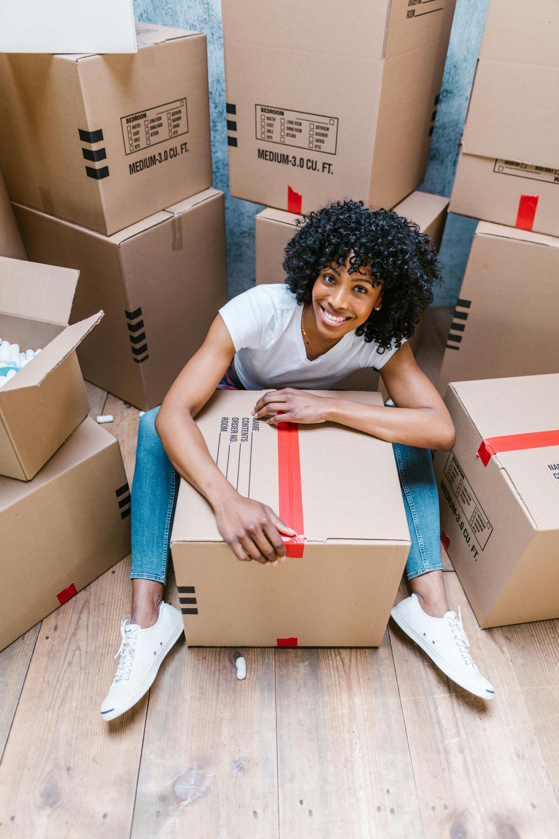 Spring cleaning and storage tips for Parchment MI residents - woman with moving boxes