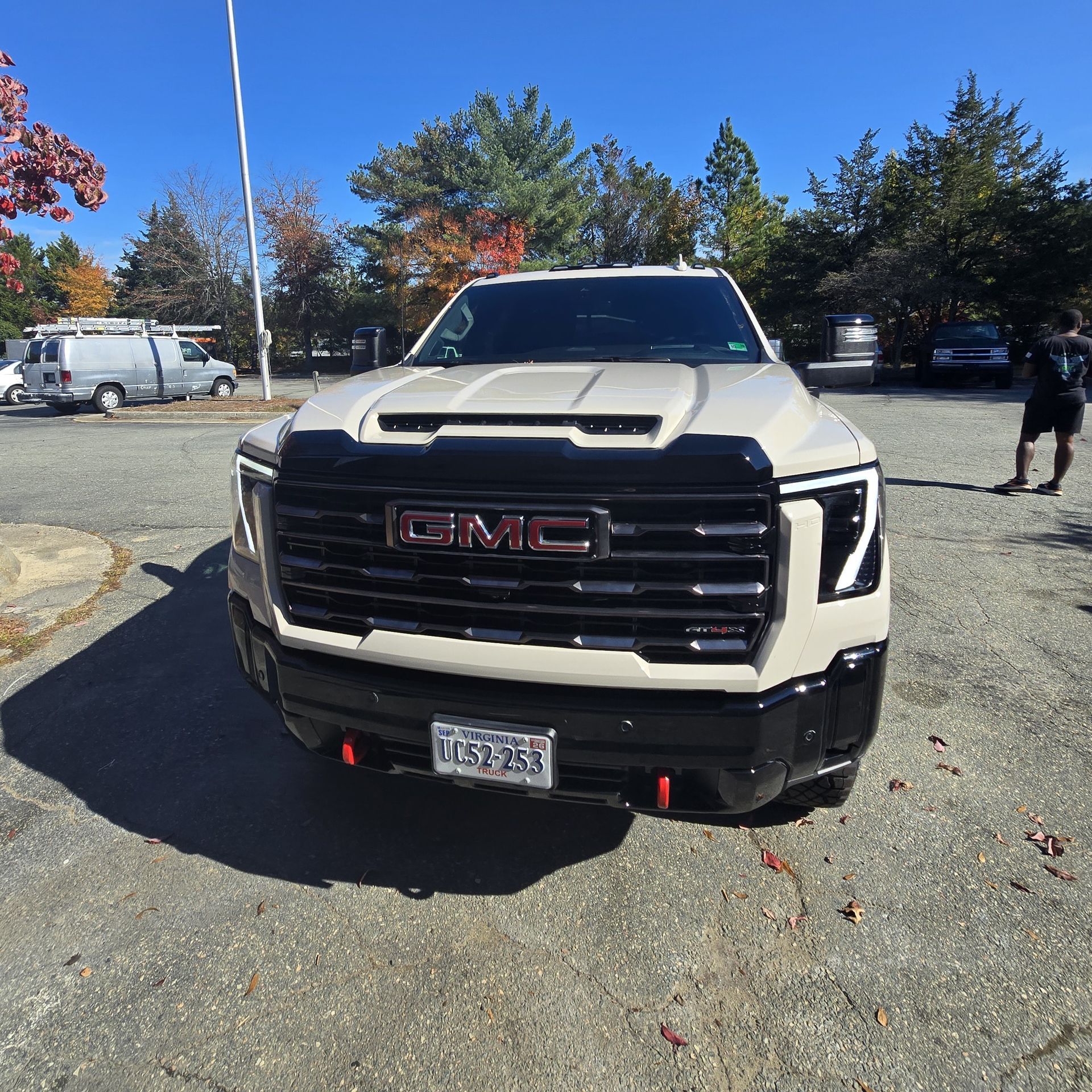 Tan GMC truck with black accents, parked in a lot, sunny day.