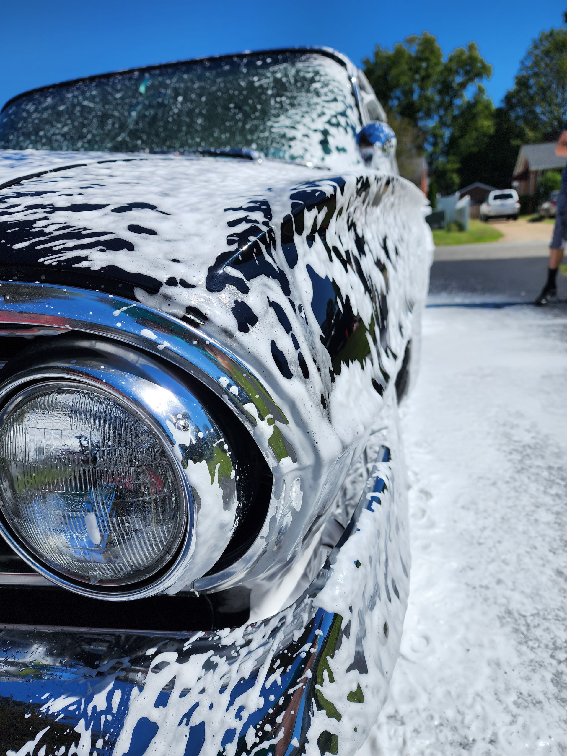 A close up of a car covered in foam