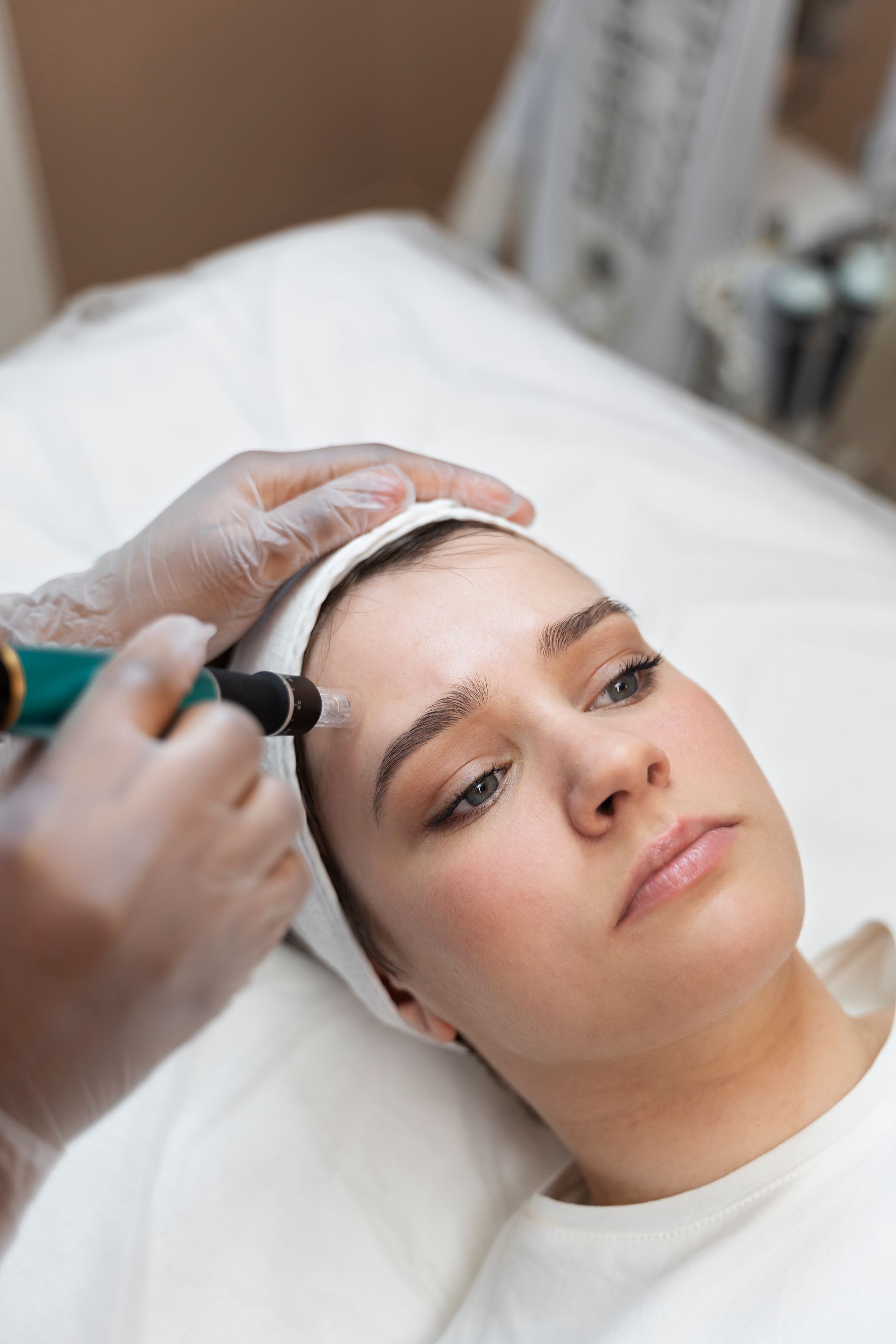 A woman is getting a facial treatment at a beauty salon.