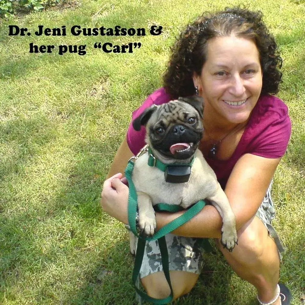 Dr. Jeni Gustafson smiling, holding pug