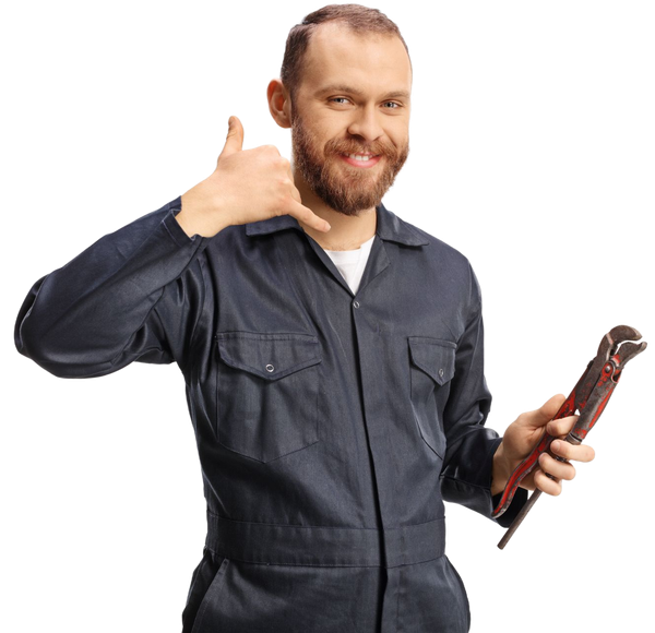 Man in blue overalls holding a wrench, making a phone call gesture, smiling.